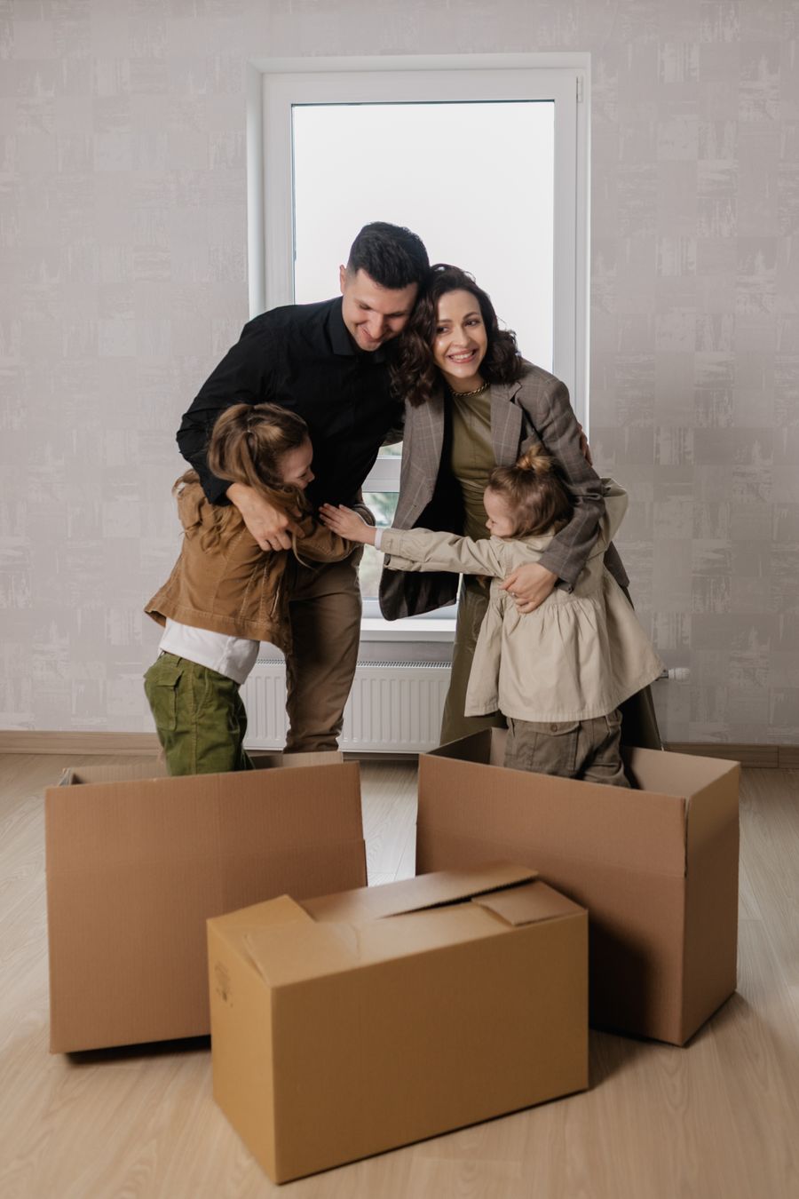 Protected family hugging happily in their insured new home