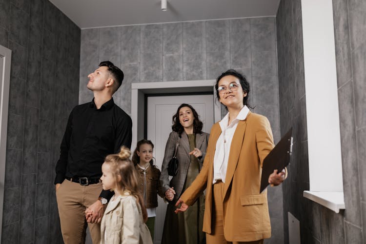 A Realtor Giving A Family A House Tour