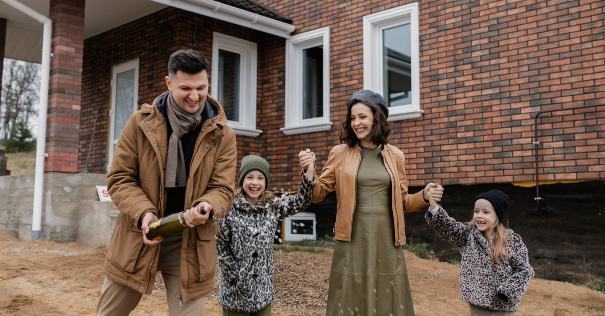 A Family Celebrating In Front Of A Brick House Free Stock Photo A Family Celebrating In Front Of A Brick House Free Stock Photo