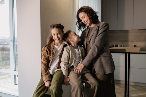 A Woman Standing Beside Her Children