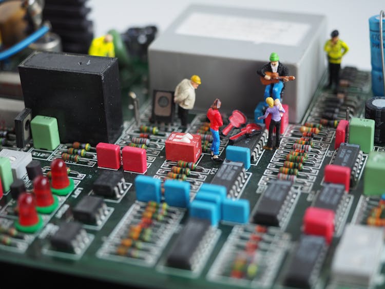 Miniature Human Figures In Motherboard