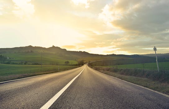 日落时分，意大利托斯卡纳空旷的道路上，捕捉到了宁静的乡村风光和连绵起伏的山丘