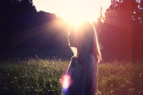 Woman Standing in Front of Sun