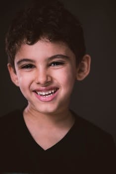 一个开朗的小男孩在摄影棚里热情地微笑着拍照