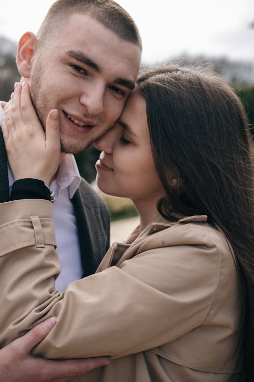 Free Crop smiling couple embracing on street in daytime Stock Photo