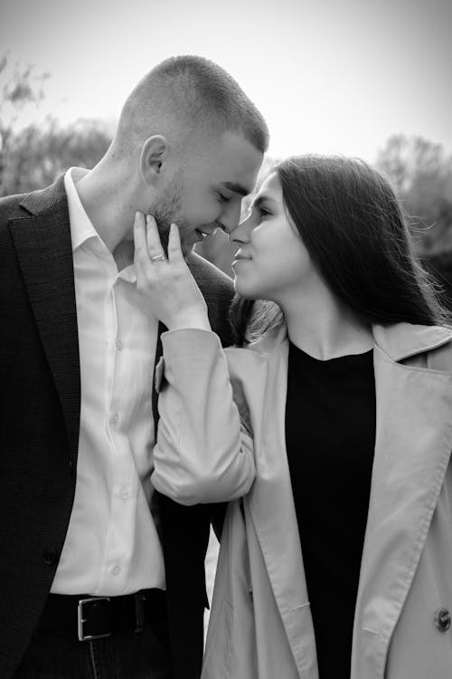 Woman caressing cheek of husband on street