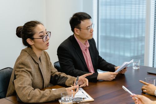 Free Two professionals engaged in a discussion during a business meeting, showcasing teamwork. Stock Photo