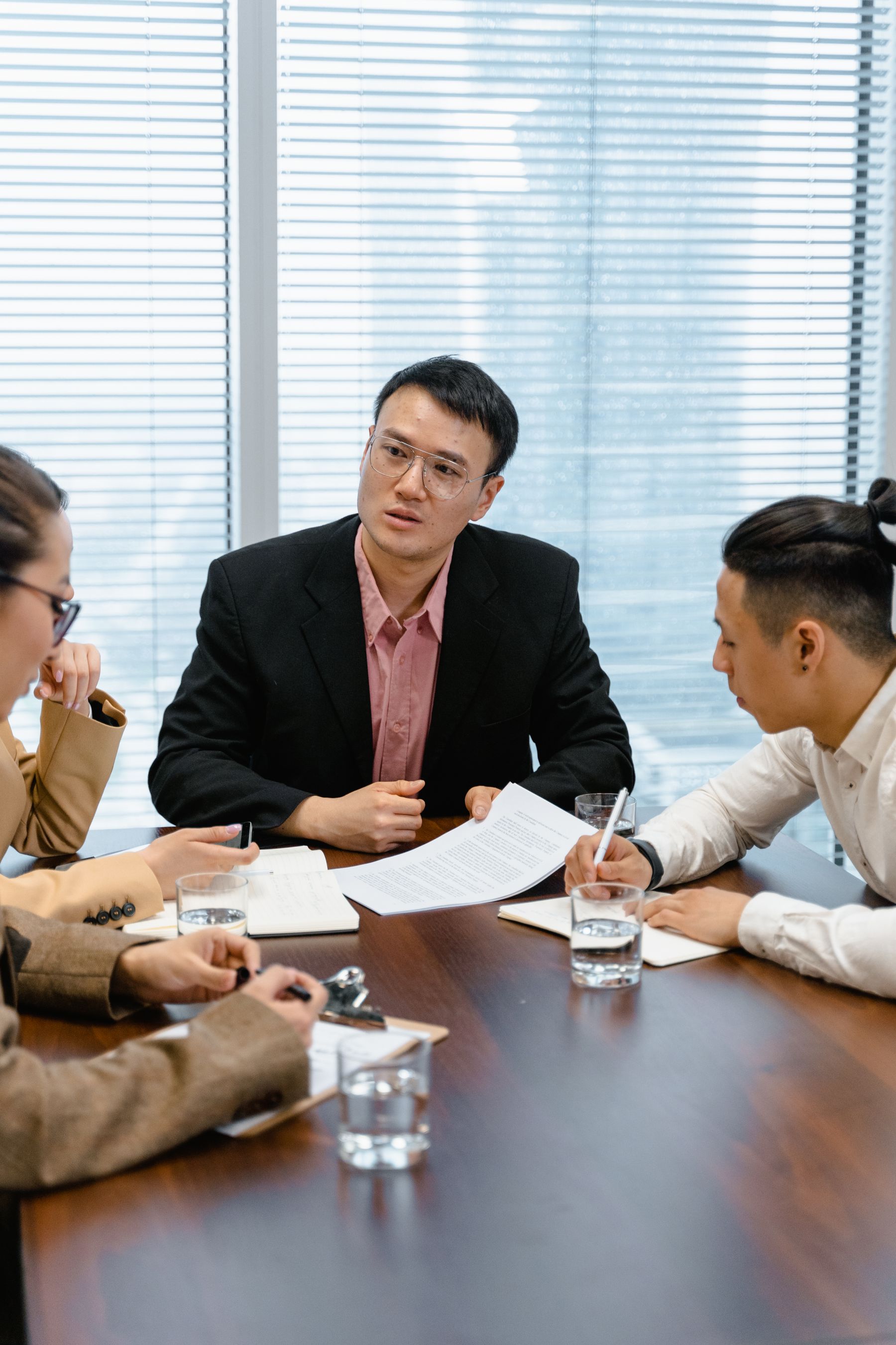 Professional team reviewing documents in a modern meeting room