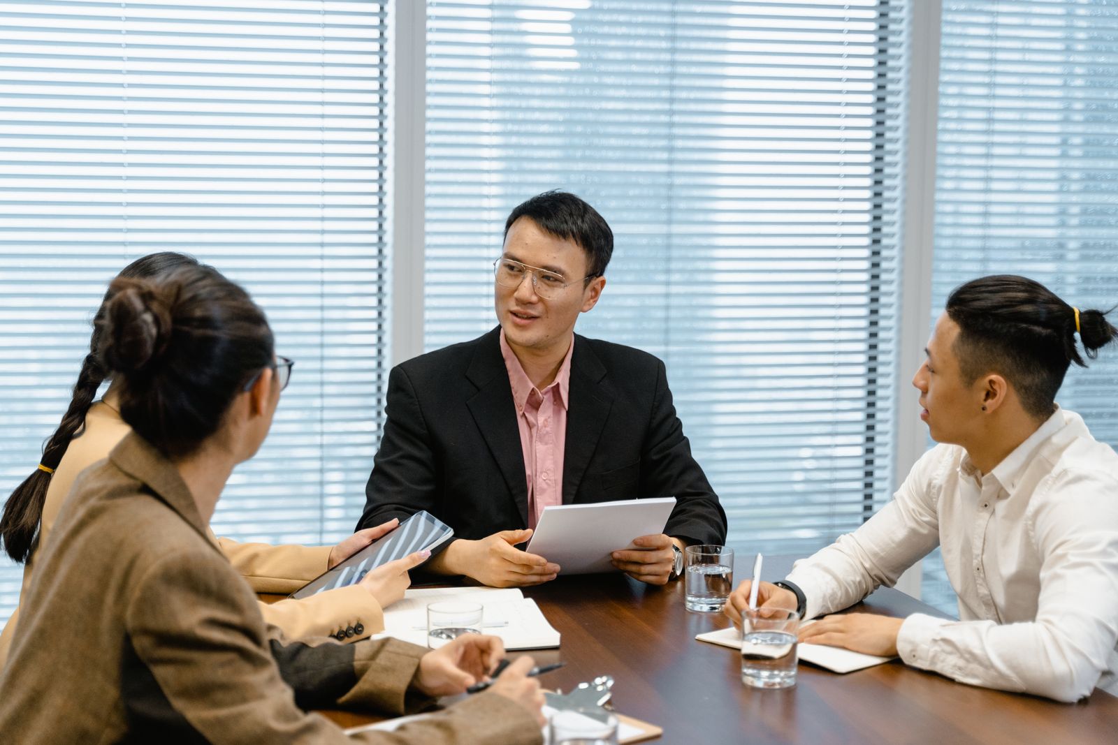 Colleagues in discussion around a meeting table