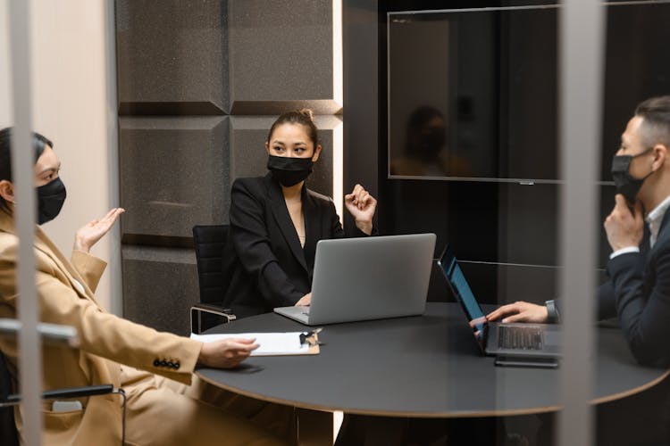 People Sitting At The Table With Laptops