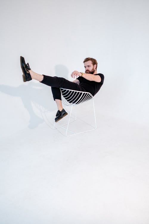 Free Cool hipster man in shoes in armchair Stock Photo