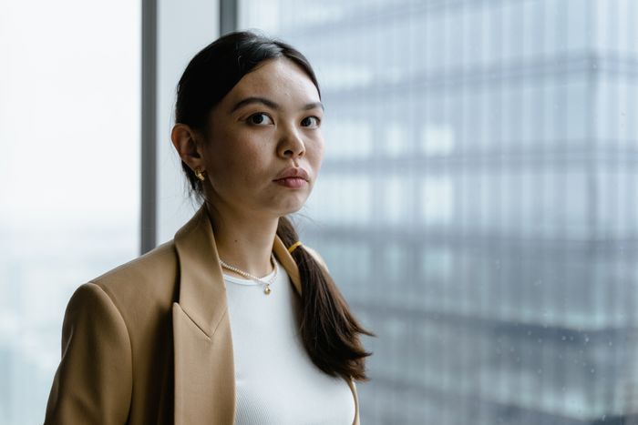 Adviser standing by an office window — MART PRODUCTION on Pexels