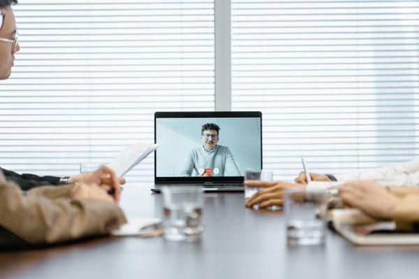 Team joining a video call in a meeting room, photo by MART PRODUCTION on Pexels