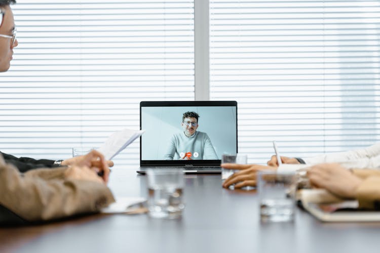 
A Man Conducting A Meeting Virtually