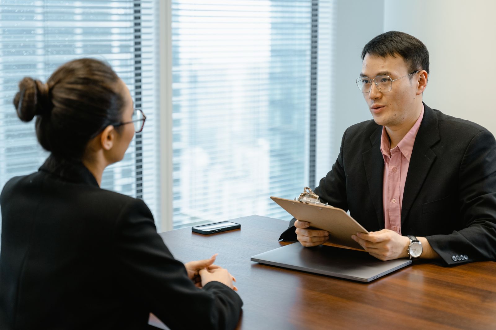 Two people talking across an office table