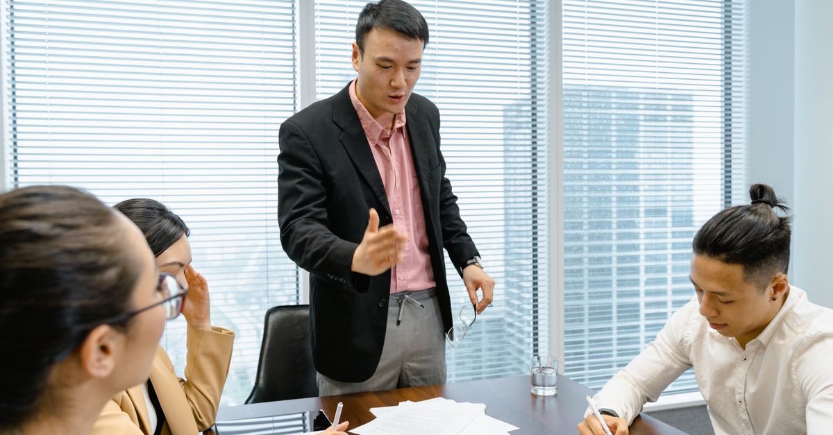 Business professionals discussing strategy during a corporate meeting in a modern boardroom.