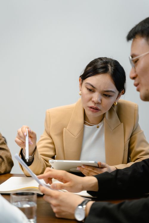 Free Professionals engaged in a business meeting, discussing documents. Stock Photo