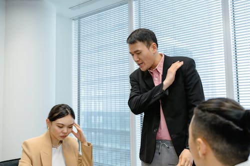 Free Man Standing and Talking Seriously to Employees Stock Photo