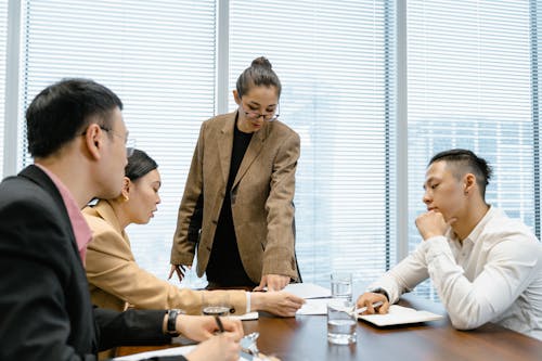 Free Team at the Meeting Listening to Woman in Glasses Stock Photo