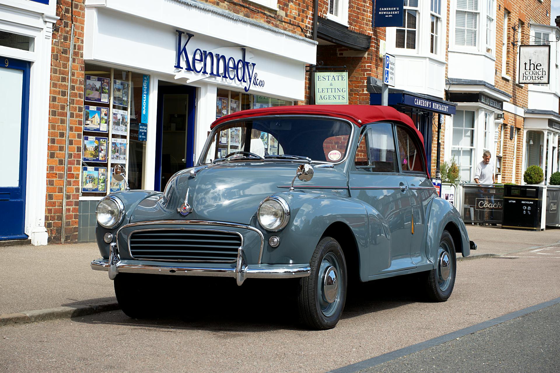 Vintage Morris Minor parked on a street in Potton, England, showcasing classic automotive design.