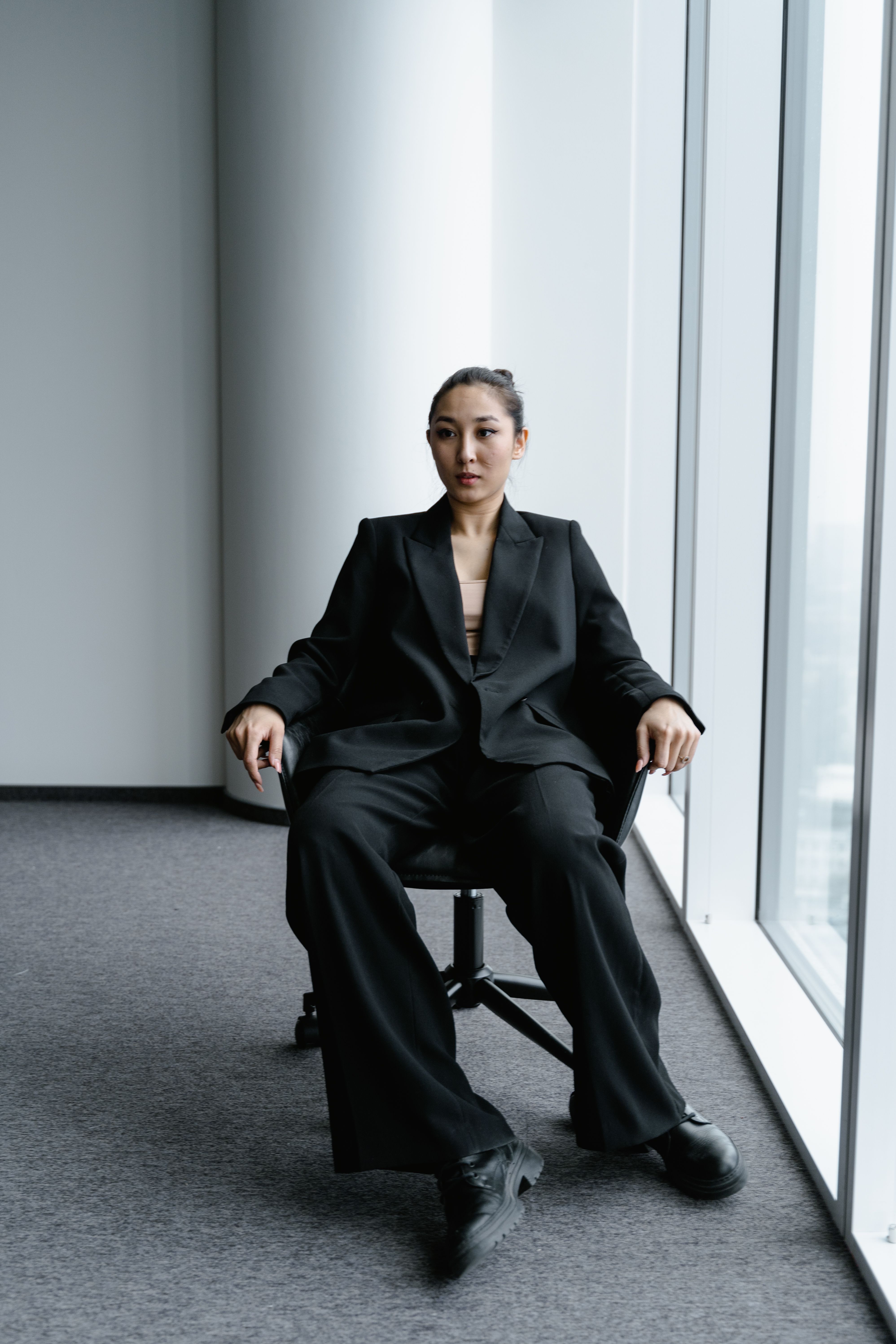 A Woman in Black Business attire Sitting on a Chair · Free Stock Photo