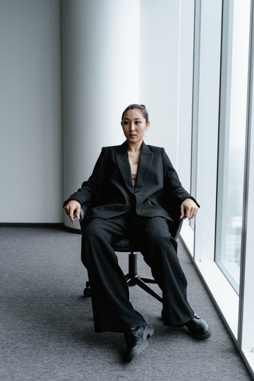 Free A Woman in Black Business attire Sitting on a Chair Stock Photo