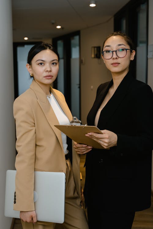 Free Women in Business Attires Inside an Office Stock Photo attire asos online miss sixty jeans fashion eyewear online clothes shopping edikted clothing valentino designer Dressy Style