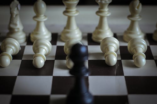 Close-Up Shot of Chess Pieces on Black and White Chessboard