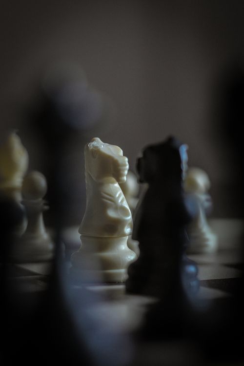 Free Close-up of chess pieces on a board emphasizing strategic gameplay. Stock Photo