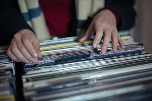 Hands browsing through a vintage vinyl record collection in a music store.