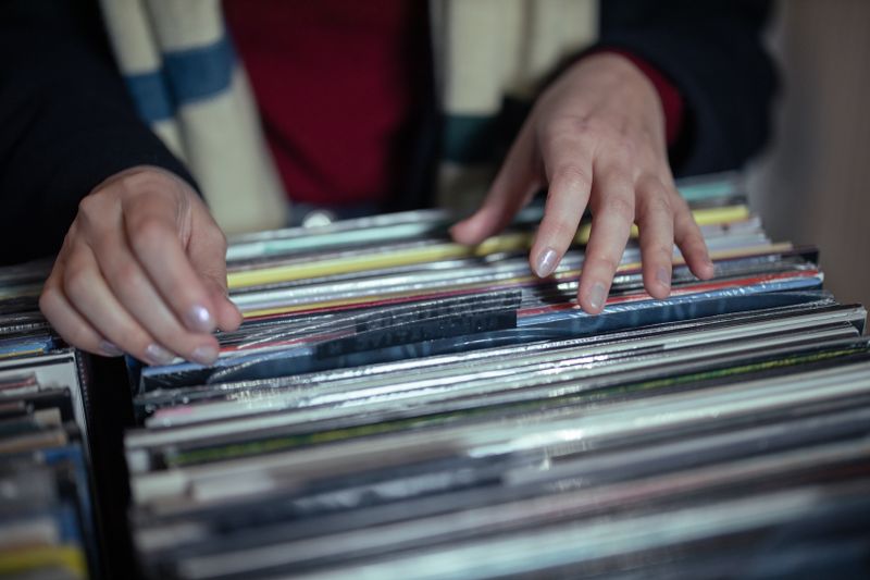 Person selecting a vinyl record