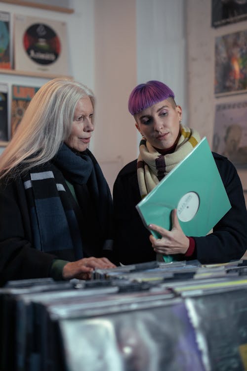 Women Looking at Vinyl Records in a Music Store