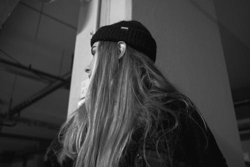 Low Angle Shot of a Woman with Long Hair Wearing a Beanie