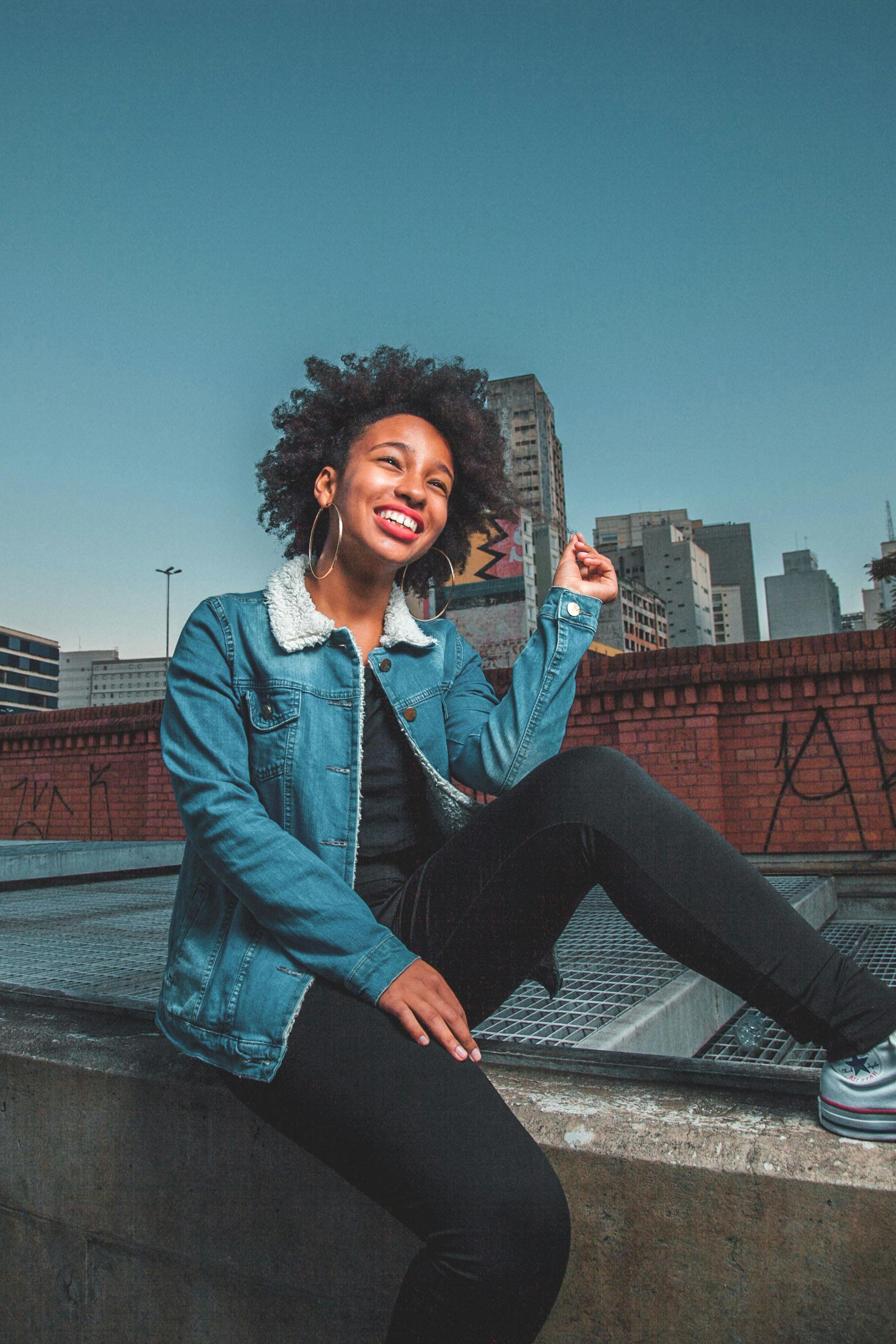 Woman in Blue Denim Jacket and Black Pants Smiling · Free Stock Photo
