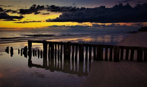 Безкоштовне стокове фото на тему «берег, дерев яний хвилеріз, Захід сонця»