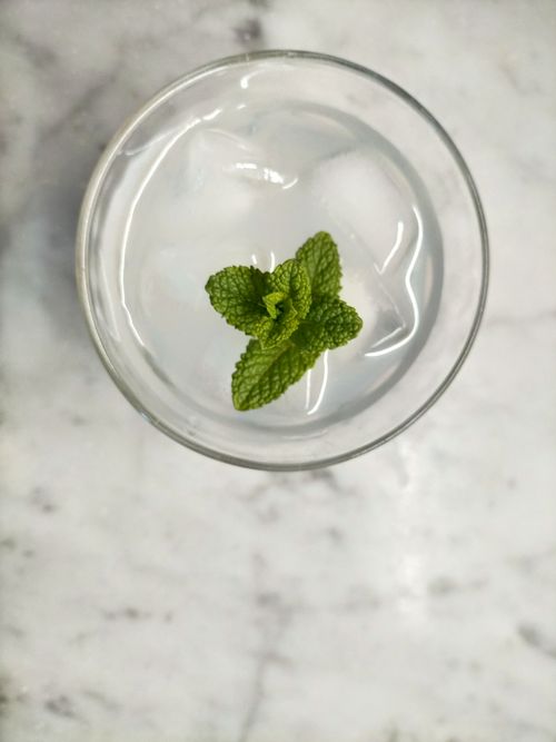 Free Top view of a refreshing iced drink with mint garnish on a marble surface. Stock Photo