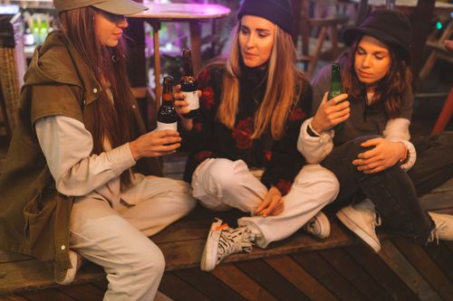 Free Casual gathering of young women enjoying drinks in a cozy setting. Stock Photo