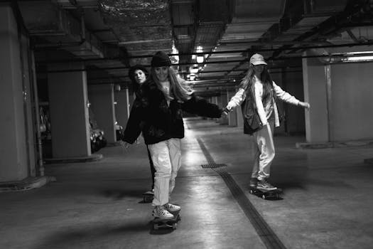 Three young women skateboarding in an underground parking lot, embracing street culture.