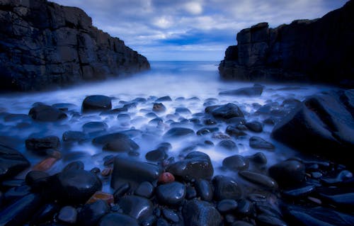 Free Rocky Shore of a Beach Between Rock Mountains Stock Photo