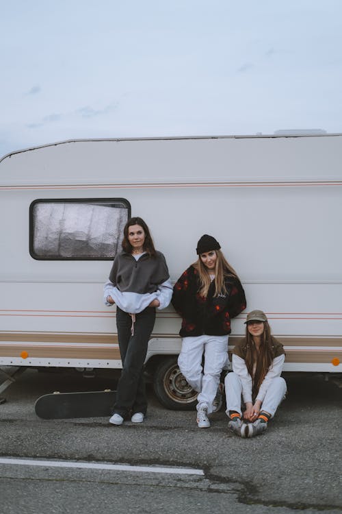 Free Young Women Leaning on a Caravan  Stock Photo