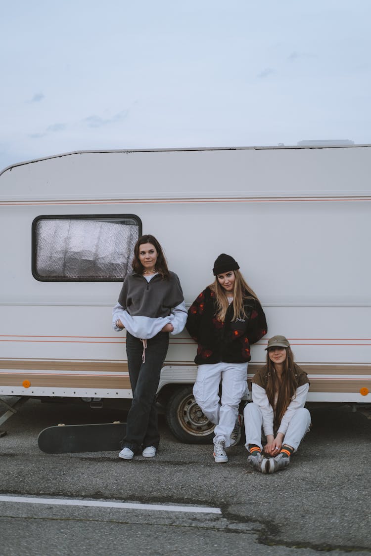 Young Women Leaning On A Caravan 