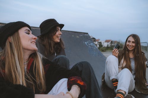 Free Friends Sitting on Skateboard Ramp Stock Photo
