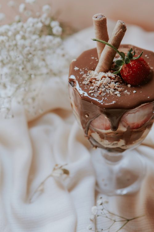 Free Indulge in this elegant dessert featuring chocolate, strawberry, and wafer sticks in a glass. Stock Photo