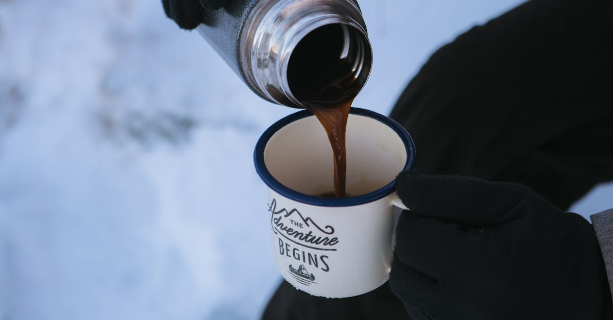 Photo of a Person Pouring Coffee in the Mug