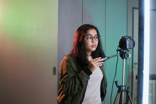 A Woman Wearing Jacket Holding Black Camera