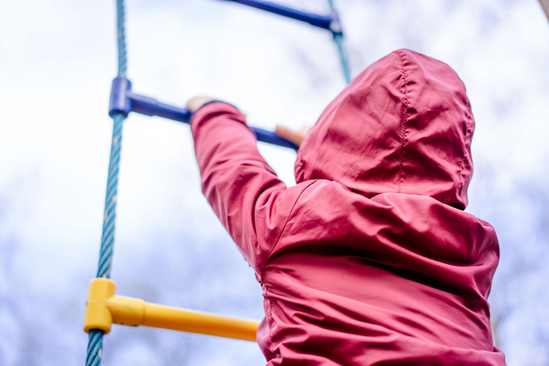 Free Kid climbing on ladder on playground Stock Photo