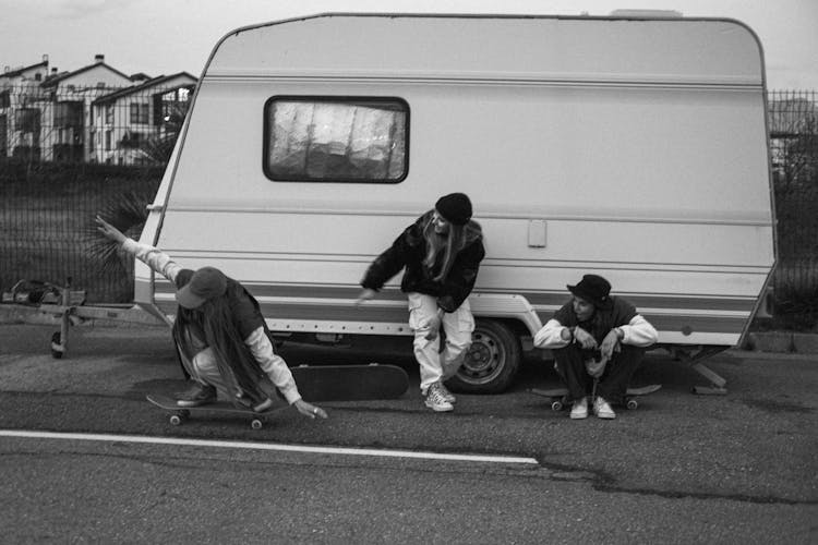 Women On The Street Near The Caravan Riding Skateboard