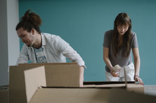 Free A couple packing boxes together, preparing for a move into their new home. Stock Photo