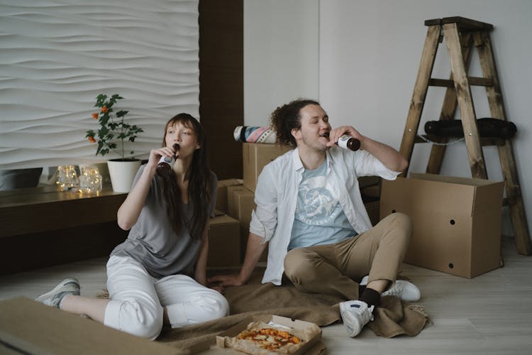 A Man And Woman Drinking Beer Together 