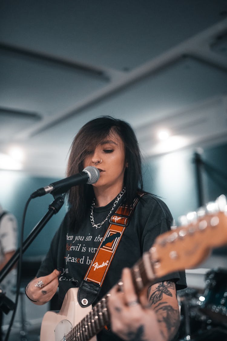 Tattooed Woman Singing In A Band